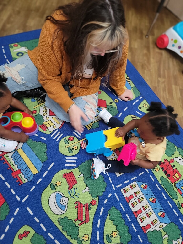 Daycare teacher and child at Johnson’s Day Care & Cradle Care in Muscle Shoals, AL